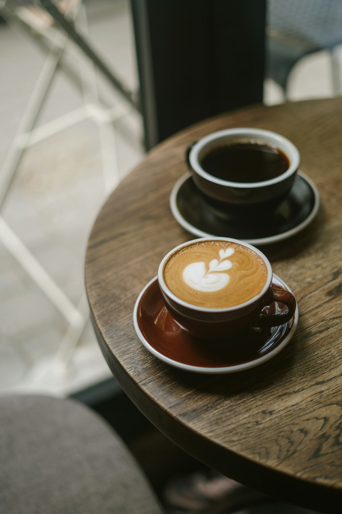 Two cups of coffee on a café table, ready for a relaxed conversation.
